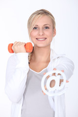 Young woman with a dumbbell and an internet @ sign