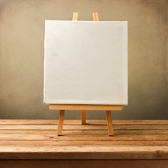 Background with blank canvas on wooden table