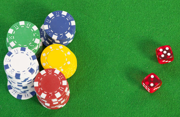 red dice on a casino table with chips  