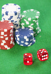 red dice on a casino table with chips  