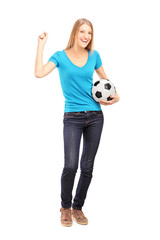 Happy female fan holding a football and gesturing