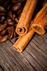 Macro photo of coffee beens with cinnamon, low depth of focus