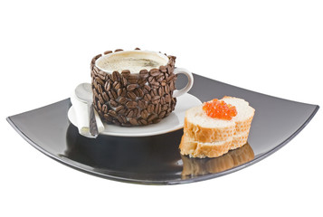 Cup of coffee with cream, red caviar. Isolated