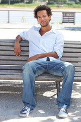 Young man sitting on bench