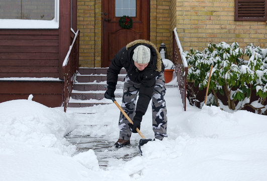 Man removing snow in front of his house