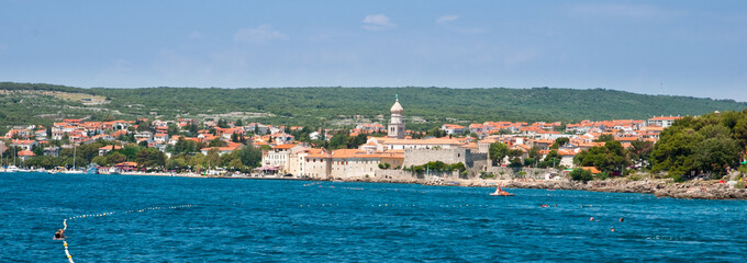 Panoramic view of Krk old town and hills from the sea - Croatia