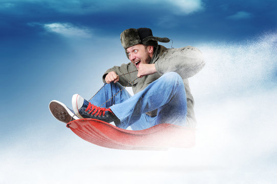 Man flying on a sleigh, concept festive sledging