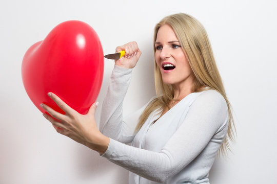 Woman destroying heart after breakup