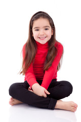 Cute young caucasian girl seated on the floor