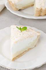 piece of lemon tart with meringue on a plate