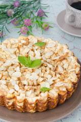 whole cottage cheese pie with apples, decorated with mint leaf