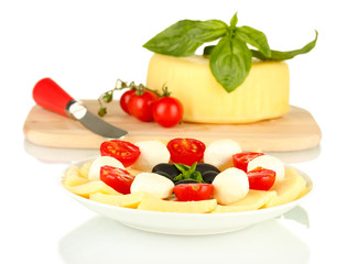 sliced mozzarella cheese with vegetables in the plate isolated