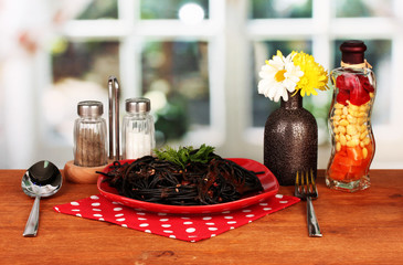 Black spaghetti on bright background