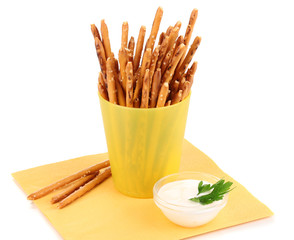 Tasty crispy sticks in yellow plastic cup isolated on white