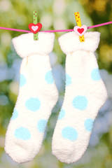 Pair of socks with polka dots hanging to dry