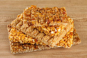 tasty sweets (kozinaki), on wooden background