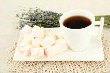 Marshmallows on plate on light background