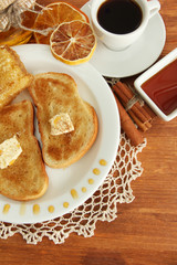 White bread toast with honey and cup of coffee on wooden table
