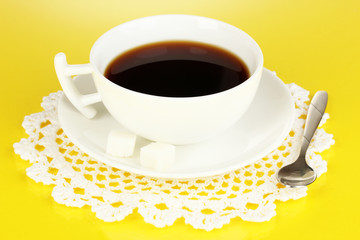 A cup of strong coffee on yellow background