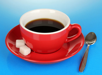 A red cup of strong coffee on blue background