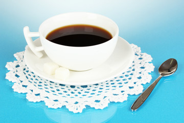 A cup of strong coffee on blue background