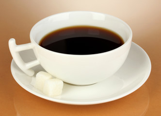 A cup of strong coffee on beige background