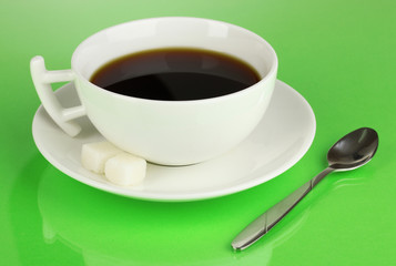 A cup of strong coffee on green background