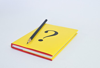 Question book with pencil on white background