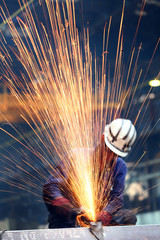 chopping metal worker in the factory - obrazy, fototapety, plakaty