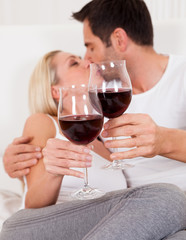 Couple toasting with red wine