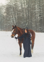 Fototapeta na wymiar Beautiful woman and horse in winter
