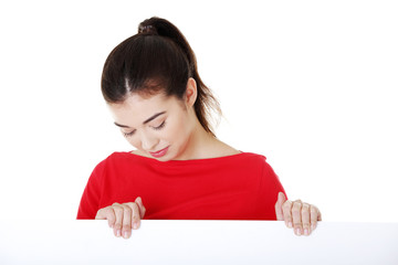 Portrait young happy woman with blank board