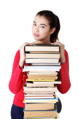 Happy young student woman with books