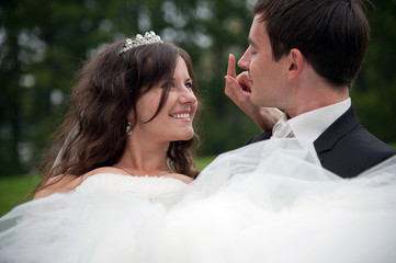 Newly married couple dancing in field