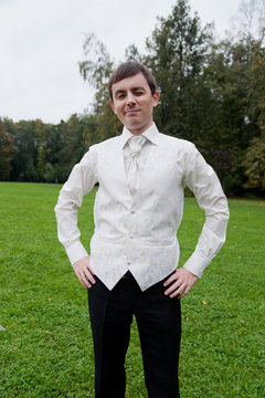 Groom stands in the field