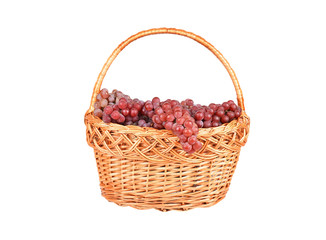 Fototapeta na wymiar Red grape in a wattled basket, isolated on a white background