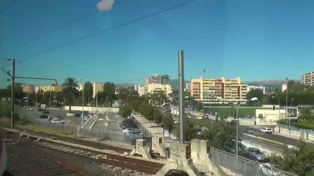 View of a city from window of moving train