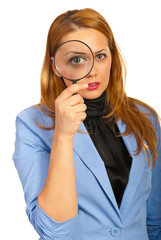 Business woman holding magnifier