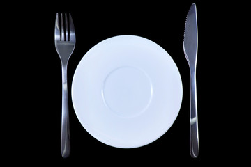 Table serving-dishware on colour backdrop.