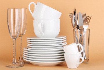 Clean white dishes on beige background