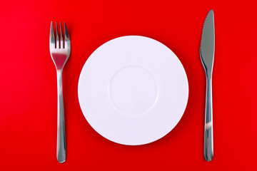 Table serving-dishware on red backdrop.