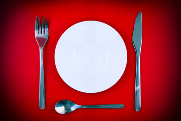 Table serving-dishware on red backdrop.