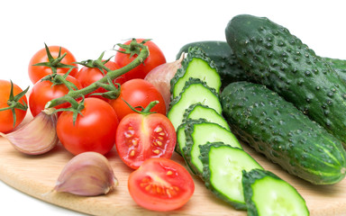 tomatoes and cucumbers on the cutting board