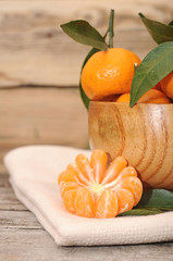 bowl of fresh mandarins on wooden table
