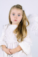 A beautiful little girl angel with a book