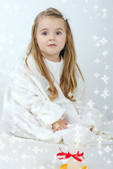 A beautiful little girl angel with a candle