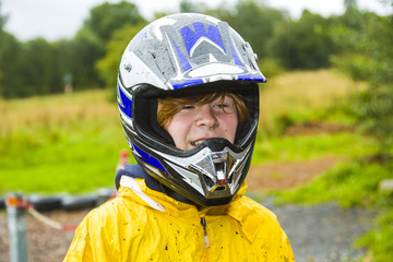 happy boy with helmet at the kart trail