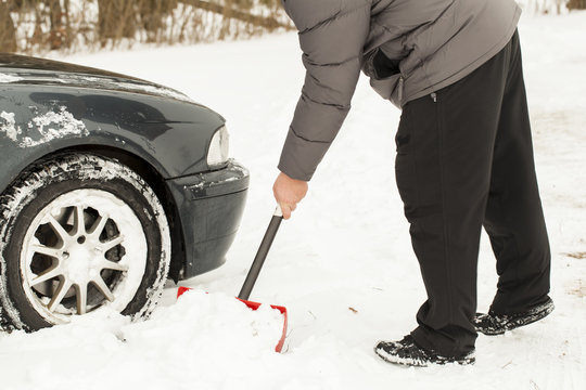Man digging car out of the snow