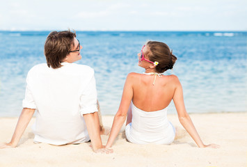 young loving couple in white on tropical beach. honeymoon