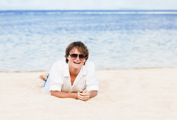 yong man in white on tropical beach